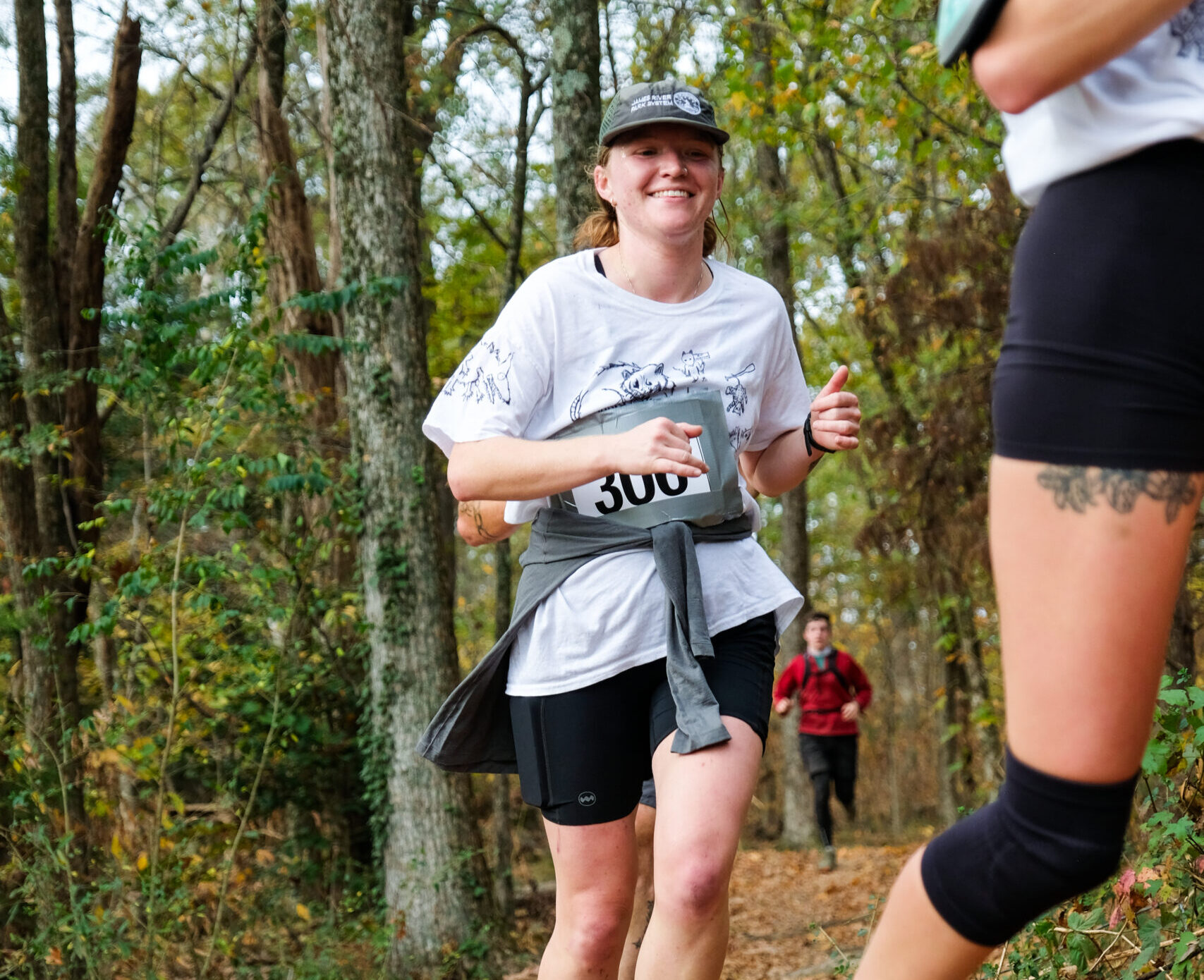 Trail runner smiling in the woods